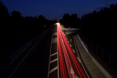 Light trails on road in city at night