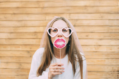 Portrait of woman holding sunglasses