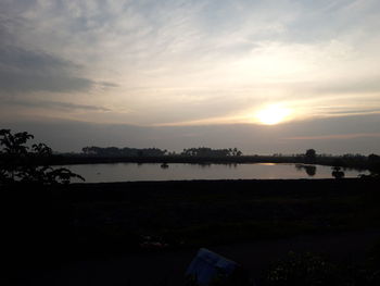 Scenic view of lake against sky during sunset