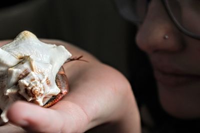 Close-up portrait of girl and hermit crab