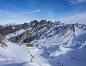 Scenic view of snowcapped mountains against sky with a snowgun in ischgl