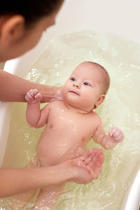 High angle view of boy washing in water