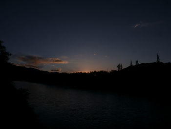 Scenic view of lake against sky at sunset