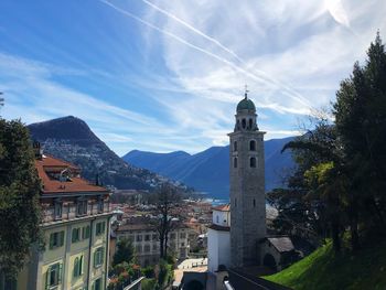 Tower amidst buildings in city against sky