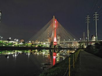 View of bridge over river at night