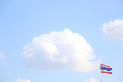 Low angle view of flag against blue sky