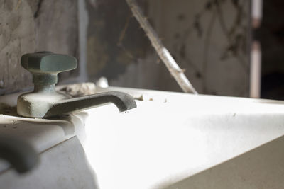 Close-up of faucet against wall