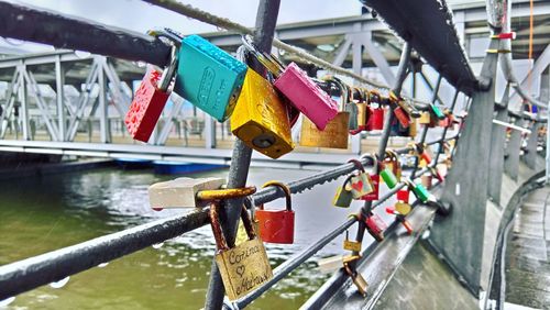 Close-up of padlocks on bridge over river