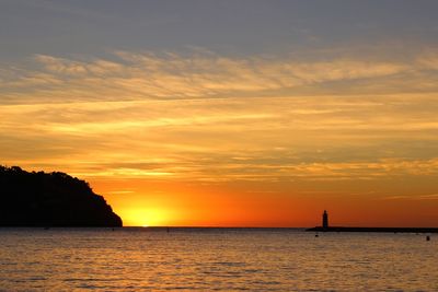 Scenic view of sea against orange sky