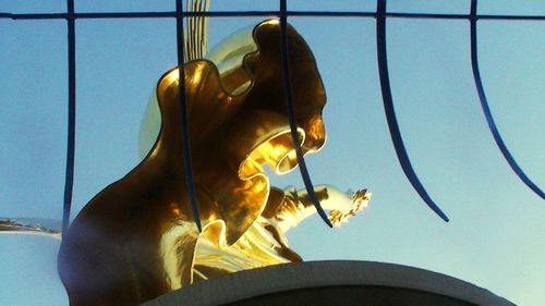 Low angle view of statue against sky