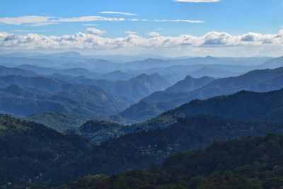 Scenic view of mountains against blue sky