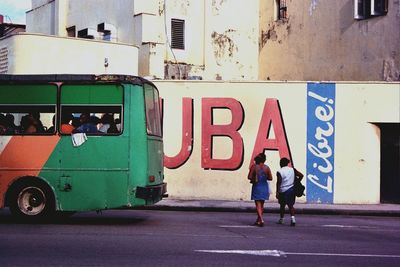 Woman walking on road in city