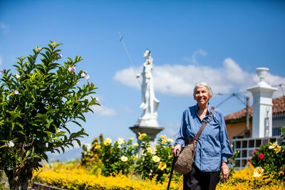 Full length of woman standing against sky