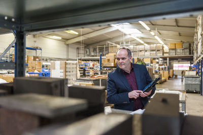 Manager checking goods in factory