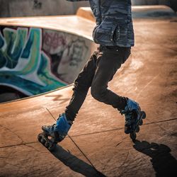 Low section of man skateboarding on skateboard