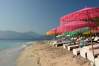 Beach umbrellas in gili air. lesser sunda islands. indonesia