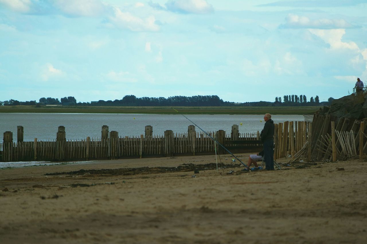 sky, tranquil scene, cloud - sky, tranquility, landscape, cloud, field, scenics, nature, sand, tree, water, beach, beauty in nature, grass, day, rural scene, outdoors, built structure, no people