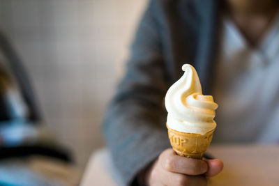 Cropped image of hand holding ice cream