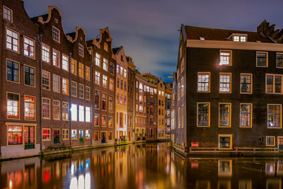 Reflection of buildings on water at night