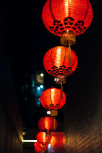 Low angle view of illuminated chinese lanterns hanging at night