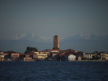 Murano is an island in the laguna of venice with a lot of glasmanufactures. in background the alps