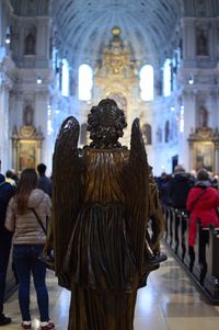 Rear view of people standing outside temple