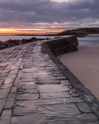 Scenic view of beach against sky during sunset