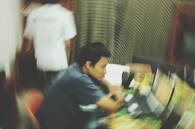 Side view of man looking through blurred motion