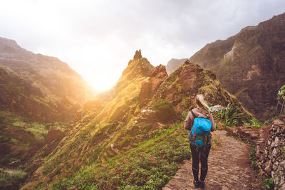 Rear view full length of woman walking on mountain