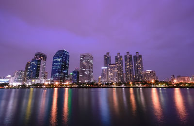 Illuminated city at waterfront