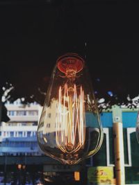 Close-up of illuminated light bulb at night