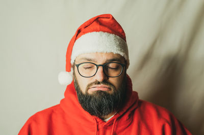 Portrait of man wearing eyeglasses against white background