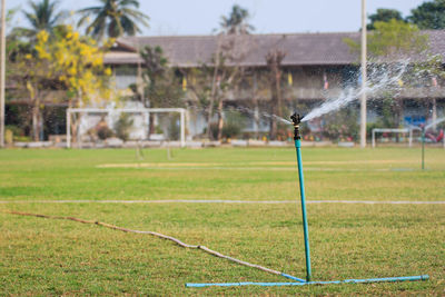 Water falling on field against trees