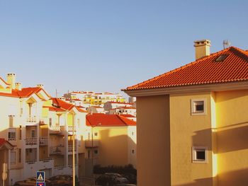 Houses in town against clear sky