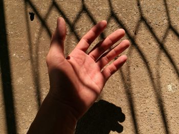 Shadow of person hand on wall