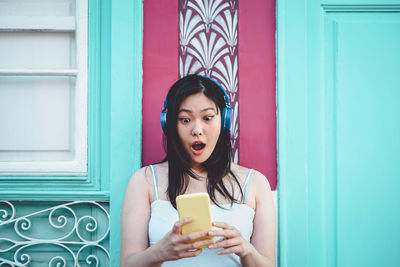 Portrait of young woman using mobile phone