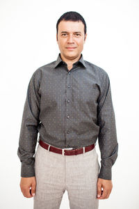 Portrait of smiling man standing against white background