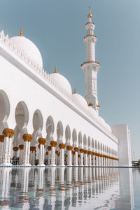 View of mosque and buildings against clear sky
