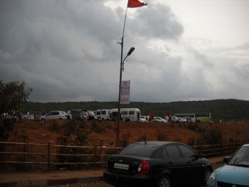 Cars on road against sky in city