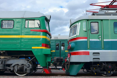 Trains at railroad station against sky