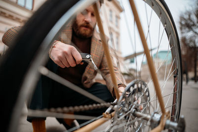 Man repairing bicycle on street