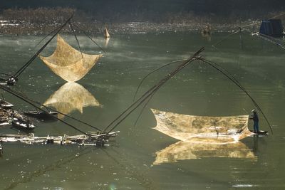 Man fishing with chinese fishing nets in lake