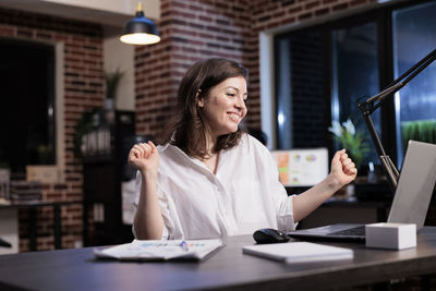 Young woman using mobile phone at office