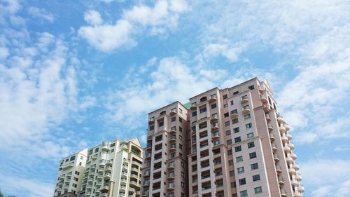Low angle view of building against cloudy sky