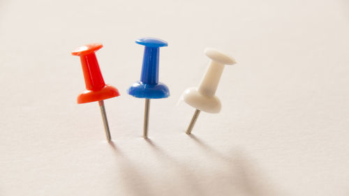 Close-up of colored pencils over white background