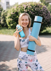 Athletic happy healthy young woman in sportswear goes after a sports workout exercise in nature