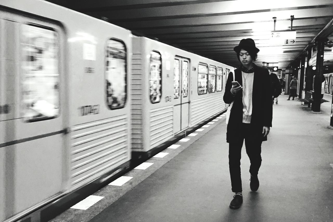 transportation, public transportation, railroad station platform, railroad station, indoors, rail transportation, lifestyles, mode of transport, train - vehicle, railroad track, subway station, travel, passenger train, passenger, men, full length, subway, person