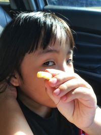 Close-up portrait of woman eating food