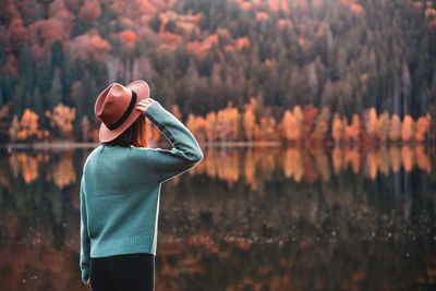 Rear view of woman standing in forest