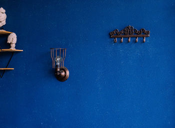 Metal hooks on the background of a blue wall. rough, uneven surface. vintage background and texture.